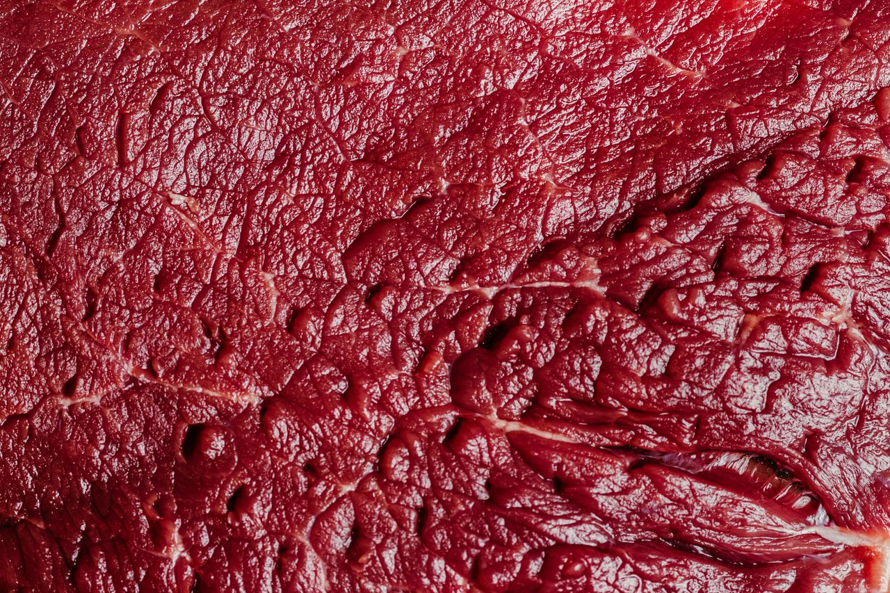 about-02 Detailed macro shot of raw beef showcasing texture and marbling.